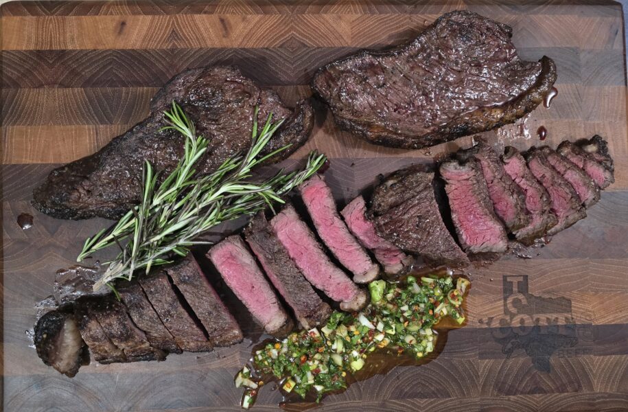 Juicy sliced steak arranged on a wooden cutting board, garnished with fresh rosemary and accompanied by a vibrant green herb sauce. Perfect for showcasing grilled meats and gourmet dining.